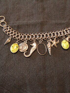 Seashore silver tone charm bracelet. Good condition.